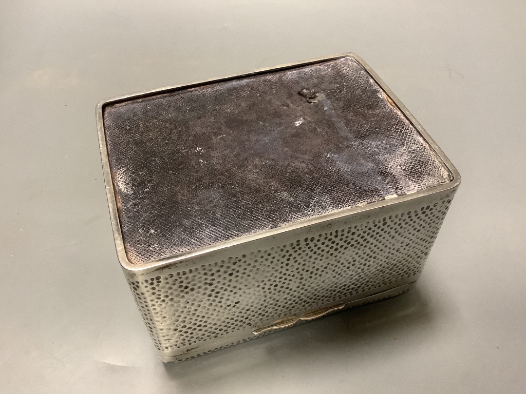 A late Victorian hammered silver cigarette box, London 1898, which 16 cm, gross weight, 32.5 ounces.